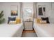 Charming bedroom featuring two twin beds, window, and minimalist decor at 14626 Wildwood Dr, Largo, FL 33774