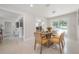This dining room features a round table with seating for six and natural light at 14626 Wildwood Dr, Largo, FL 33774