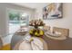 Decoratively set dining table with place settings and flowers, with a view of the pool area at 14626 Wildwood Dr, Largo, FL 33774