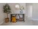 Entryway table with mirror and decorative elements, with open view into the rest of the home at 14626 Wildwood Dr, Largo, FL 33774