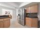 Kitchen with stainless steel refrigerator and light wood cabinets at 14626 Wildwood Dr, Largo, FL 33774