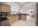 Bright kitchen with stainless steel appliances, granite countertops, and a window overlooking the backyard at 14626 Wildwood Dr, Largo, FL 33774