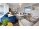 Stylish living room with modern decor, a blue sofa, and bright lighting at 14626 Wildwood Dr, Largo, FL 33774