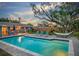 Sparkling in-ground pool surrounded by a brick patio, lounge chairs, and a hammock for relaxation at 14626 Wildwood Dr, Largo, FL 33774