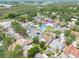 An aerial view of the neighborhood displaying a home with a pool near a lake at 1472 Bay View St, Tarpon Springs, FL 34689