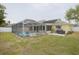 Backyard with pool, screened enclosure, patio, and grill at 1472 Bay View St, Tarpon Springs, FL 34689