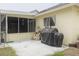 Backyard with patio and grill, screened patio, and view of a neighboring backyard at 1472 Bay View St, Tarpon Springs, FL 34689