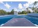 Community basketball court with blue surface and playground in background on a bright sunny day at 1472 Bay View St, Tarpon Springs, FL 34689