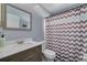 Modern bathroom with updated vanity, chevron shower curtain and toilet at 1472 Bay View St, Tarpon Springs, FL 34689