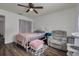 Bedroom with ceiling fan, window, plush chair, ottoman, and a comfy bed at 1472 Bay View St, Tarpon Springs, FL 34689