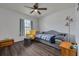 Bedroom with wood floors, a ceiling fan, sitting area, and large window at 1472 Bay View St, Tarpon Springs, FL 34689