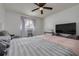 Bedroom with window, tv, and comfy bed and chair at 1472 Bay View St, Tarpon Springs, FL 34689