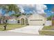 Charming single Gathering home with a well-manicured front yard and two-car garage at 1472 Bay View St, Tarpon Springs, FL 34689