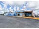 Commercial building featuring a blue exterior with colorful murals and flags on a sunny day at 1472 Bay View St, Tarpon Springs, FL 34689