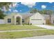 Charming single-Gathering home featuring a well-maintained lawn and a two-car garage at 1472 Bay View St, Tarpon Springs, FL 34689