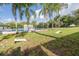Community games area, featuring a cornhole game with the pool and playground nearby at 1472 Bay View St, Tarpon Springs, FL 34689