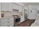 Well-equipped kitchen with stainless steel appliances, granite counters, and white cabinetry at 1472 Bay View St, Tarpon Springs, FL 34689