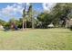 Green community playground featuring swings and slide at 1472 Bay View St, Tarpon Springs, FL 34689