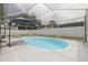 Sparkling blue pool and screened-in enclosure with privacy fence and sun umbrella at 1472 Bay View St, Tarpon Springs, FL 34689