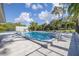 Community swimming pool and recreational area with chairs and playground equipment at 1472 Bay View St, Tarpon Springs, FL 34689