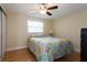Bright bedroom features a ceiling fan, natural light, hardwood floors, and a large closet with sliding doors at 1500 Ohio Ne Ave, St Petersburg, FL 33703