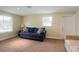 Cozy living room with plush carpet, bright windows, and a comfortable blue sofa with patterned pillows at 1500 Ohio Ne Ave, St Petersburg, FL 33703