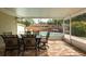 Covered patio with dining set overlooks a sparkling pool and outdoor seating area, perfect for entertaining at 1500 Ohio Ne Ave, St Petersburg, FL 33703