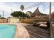 Backyard oasis featuring a refreshing pool, sun deck, lounge area, and privacy fence, ideal for relaxation at 1500 Ohio Ne Ave, St Petersburg, FL 33703