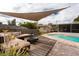 Beautiful pool with a wooden deck and outdoor seating. An outdoor dining area can be seen on the screened patio at 1500 Ohio Ne Ave, St Petersburg, FL 33703