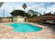 Backyard oasis featuring a refreshing pool, sun deck, lounge area, and privacy fence, ideal for relaxation at 1500 Ohio Ne Ave, St Petersburg, FL 33703