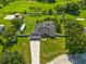 Aerial view of the property with a screened-in pool, a large yard, and a long driveway at 1521 Avondale Ridge Dr, Plant City, FL 33567