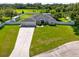 Aerial view of a lovely home with a three-car garage, expansive driveway, and spacious backyard at 1521 Avondale Ridge Dr, Plant City, FL 33567