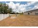 Large backyard with well maintained fence and partial view of the house at 1521 Avondale Ridge Dr, Plant City, FL 33567