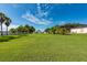 Expansive backyard with lush green grass and mature trees creating a serene setting at 1521 Avondale Ridge Dr, Plant City, FL 33567