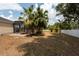 Backyard view showing the screened lanai with pool access and partial view of the expansive yard at 1521 Avondale Ridge Dr, Plant City, FL 33567