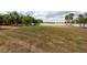 Large backyard featuring a fence and mature trees, providing privacy and space for outdoor enjoyment at 1521 Avondale Ridge Dr, Plant City, FL 33567