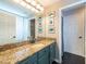 Bright bathroom featuring granite countertops, a large mirror, and modern fixtures at 1521 Avondale Ridge Dr, Plant City, FL 33567