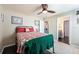 Cozy bedroom with a ceiling fan, a decorative quilt, and convenient access to the bathroom at 1521 Avondale Ridge Dr, Plant City, FL 33567