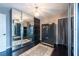 Bedroom featuring a large closet with mirrored doors, dark floors, and chandelier lighting at 1521 Avondale Ridge Dr, Plant City, FL 33567