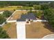Aerial view of a single-Gathering home showing the large lawn, trees, and fence at 1521 Avondale Ridge Dr, Plant City, FL 33567