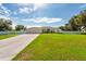 Spacious single-story home featuring a three-car garage and a pristine front lawn at 1521 Avondale Ridge Dr, Plant City, FL 33567