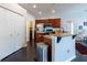Eat-in kitchen featuring granite countertop and breakfast bar, stainless steel appliances, and dark wood cabinets at 1521 Avondale Ridge Dr, Plant City, FL 33567