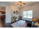 Cozy living room featuring a ceiling fan and a large window view of the pool at 1521 Avondale Ridge Dr, Plant City, FL 33567