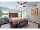 Comfortable main bedroom showcasing a ceiling fan, a decorative rug, and a wooden bed frame at 1521 Avondale Ridge Dr, Plant City, FL 33567