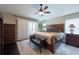 Relaxing main bedroom with a ceiling fan, a sitting bench, and abundant natural light at 1521 Avondale Ridge Dr, Plant City, FL 33567