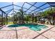 Beautiful, screened-in pool with waterfall feature and lush tropical landscaping at 1521 Avondale Ridge Dr, Plant City, FL 33567