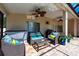 Covered patio area with wicker seating, ceiling fans, and brick-paved flooring next to screened pool at 1521 Avondale Ridge Dr, Plant City, FL 33567