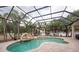 A beautiful enclosed pool area with a waterfall feature and a jacuzzi at 1521 Avondale Ridge Dr, Plant City, FL 33567