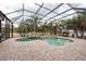 A beautiful enclosed pool area with a waterfall feature and a jacuzzi at 1521 Avondale Ridge Dr, Plant City, FL 33567