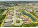 Aerial view of neighborhood with pond and community pool, and highlighted home location at 15303 Valencia Del Sol St, Wimauma, FL 33598